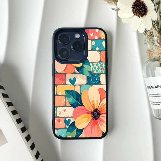 Phone case featuring large stylized flowers over a colorful mosaic brick pattern in teal, yellow, and orange.